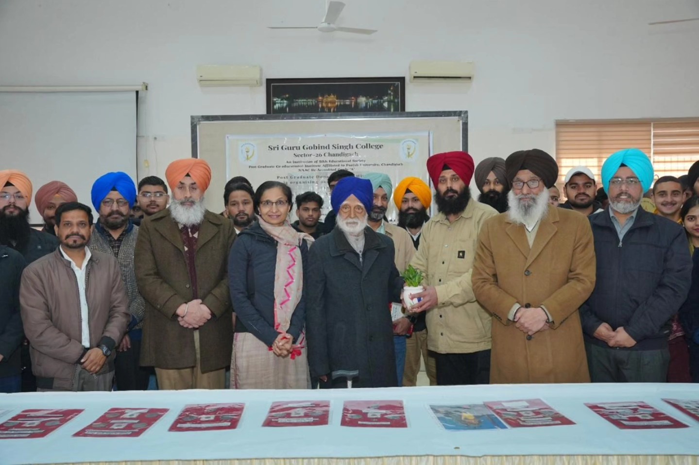 S. Davinder Singh being felicitated by S. Gurdev Singh, President SES, along with the Principal, SGGS College, and faculty members.